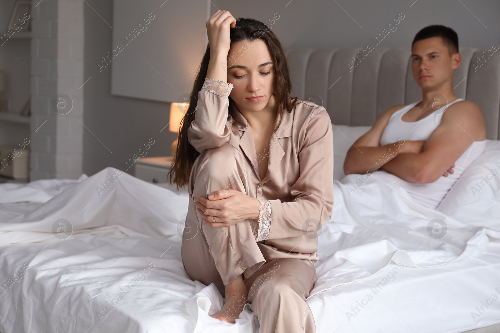 Photo of Offended couple after quarrel in bedroom. Relationship problem