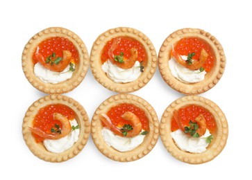 Delicious canapes with shrimps, red caviar and cream cheese isolated on white, top view