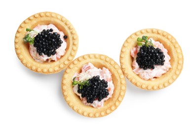 Delicious canapes with black caviar isolated on white, top view