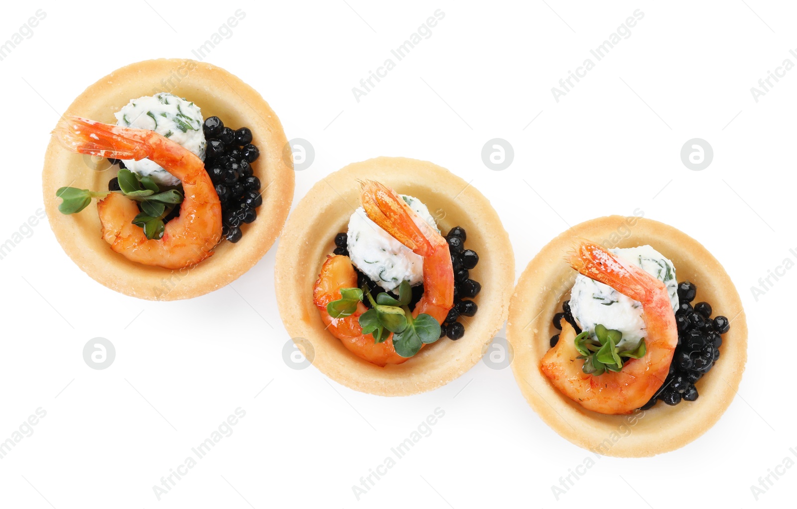 Photo of Delicious canapes with shrimps and black caviar isolated on white, top view