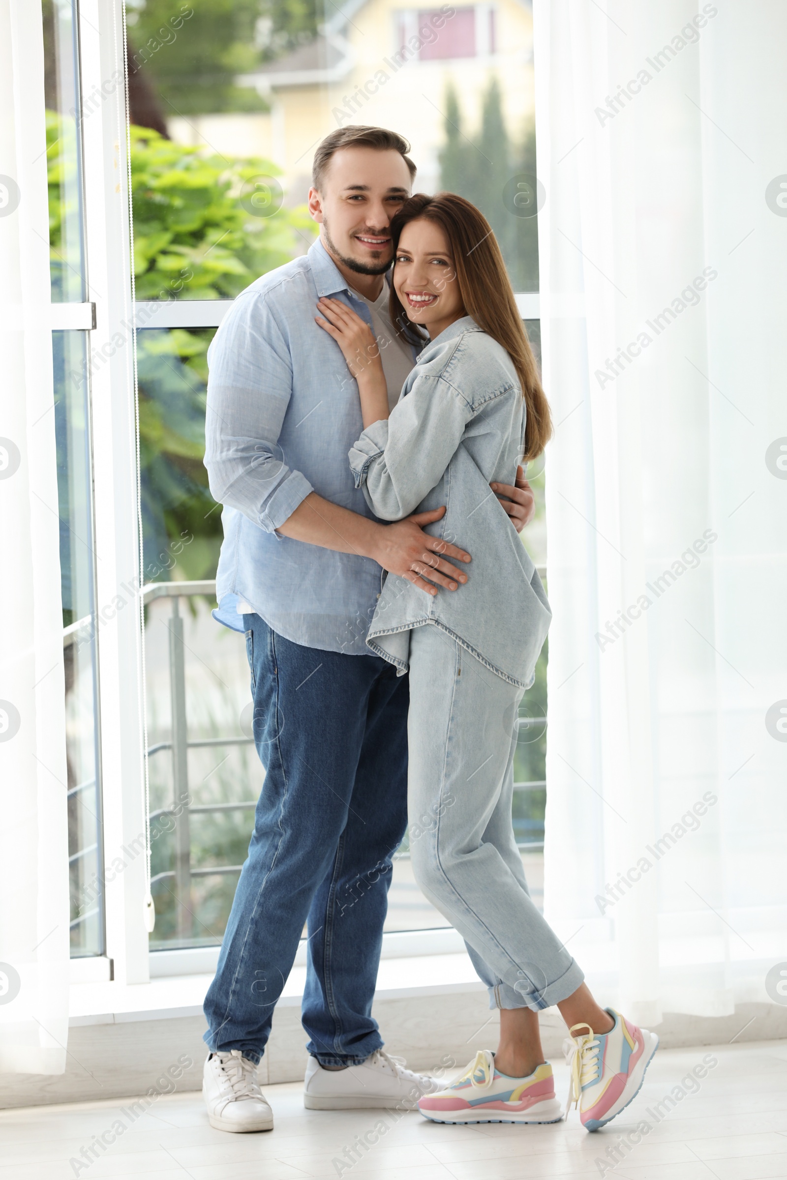 Photo of Happy couple hugging at home. Strong relationship