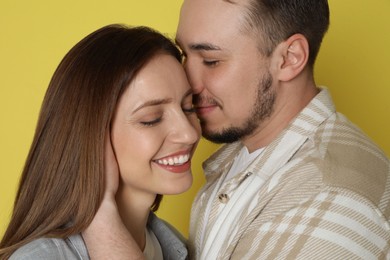 Photo of Happy couple on yellow background. Strong relationship