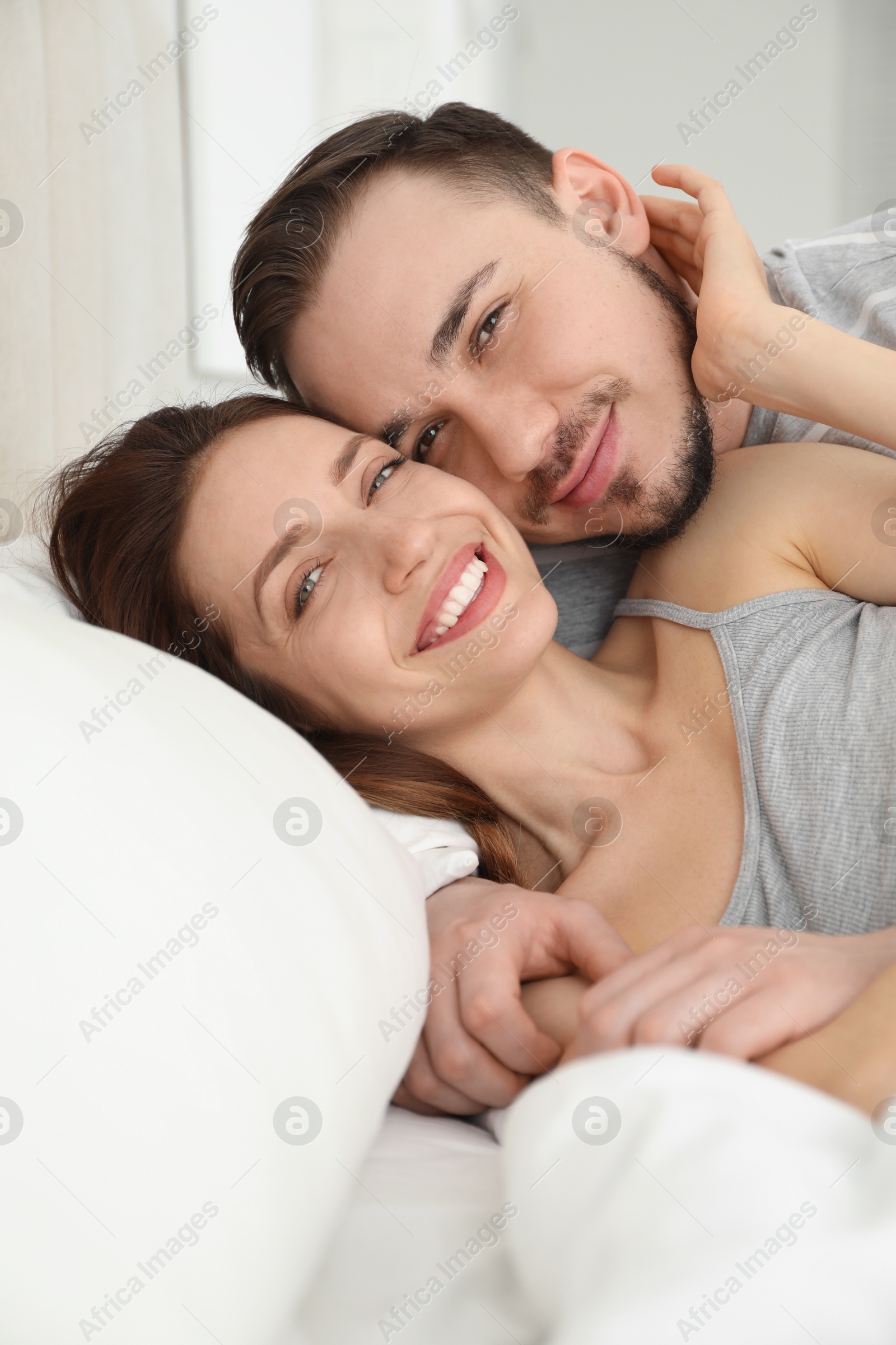 Photo of Family portrait of lovely couple on bed at home