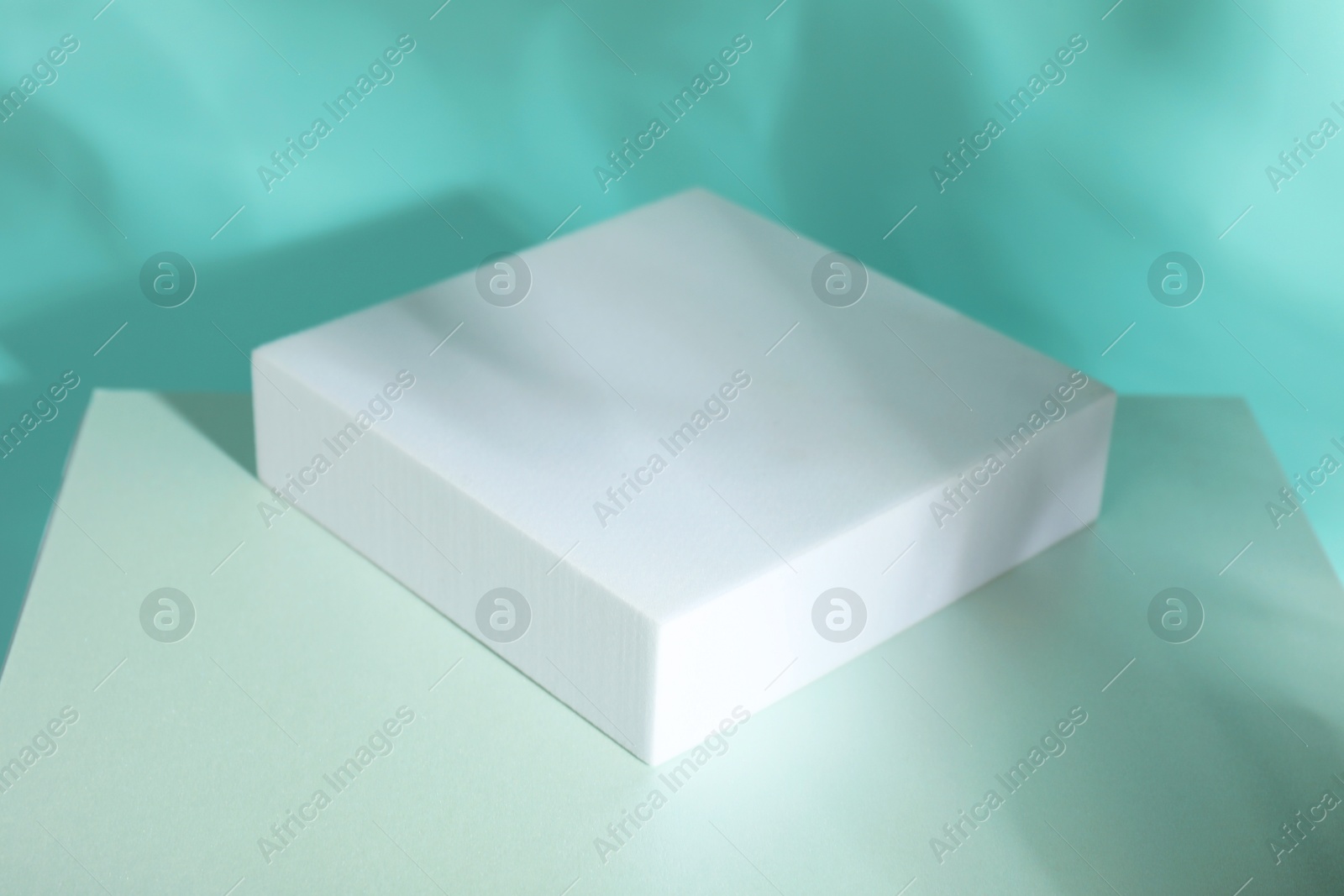 Photo of Presentation of product. Podiums and shadows on turquoise background. Space for text