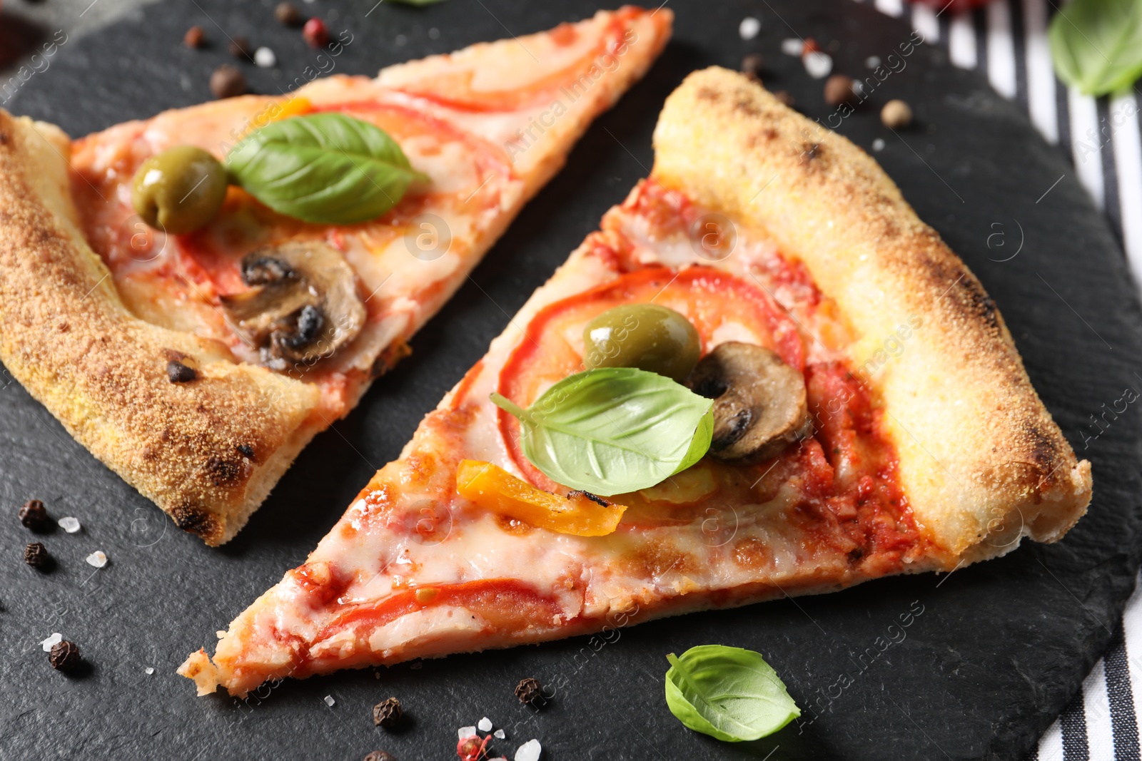 Photo of Cut delicious vegetarian pizza and spices on table