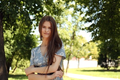 Portrait of beautiful woman in summer park, space for text