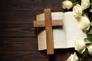Bible, cross and roses on wooden table, top view with space for text. Religion of Christianity