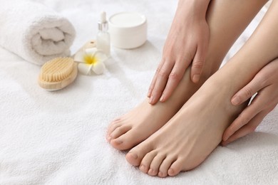 Closeup view of woman`s groomed feet after care procedure on soft towel