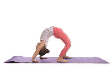 Photo of Cute little girl doing gymnastic exercise on white background