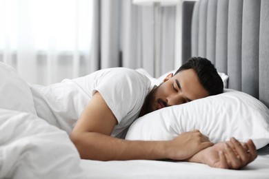 Handsome man sleeping in bed at morning