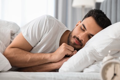 Handsome man sleeping in bed at morning