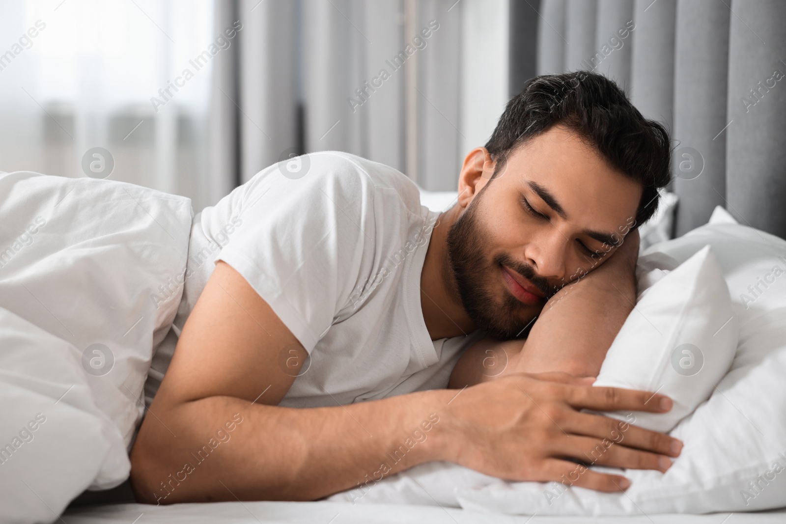 Photo of Handsome man sleeping in bed at morning