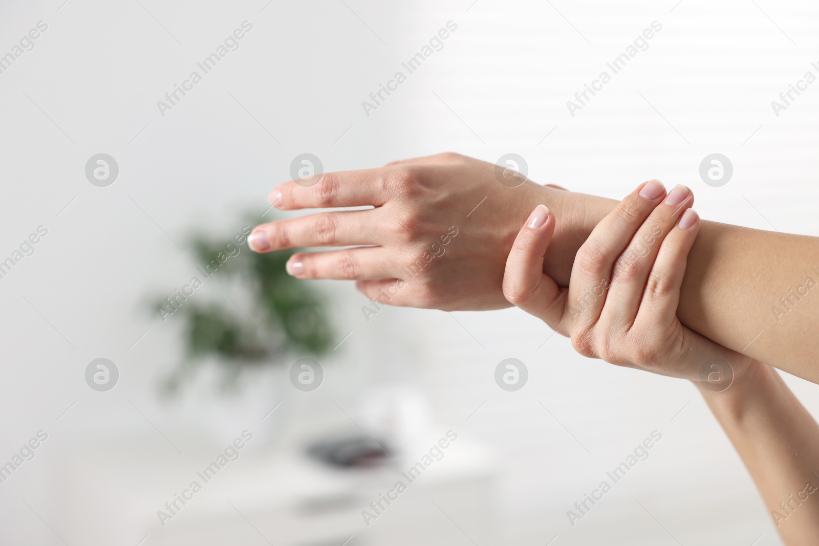 Photo of Sports injury. Woman with pain in wrist in hospital, closeup