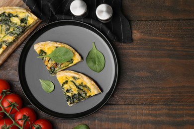 Photo of Pieces of delicious pie with spinach on wooden table, flat lay. Space for text