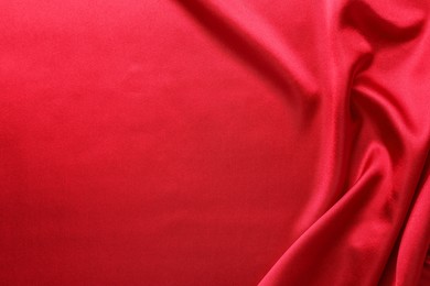 Photo of Texture of beautiful red silk fabric as background, closeup