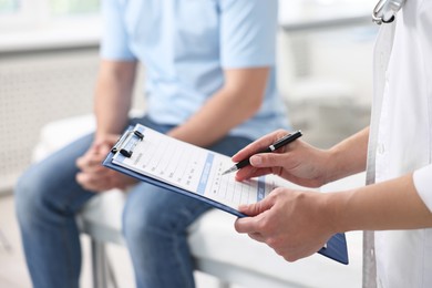 Professional doctor working with patient in hospital, closeup