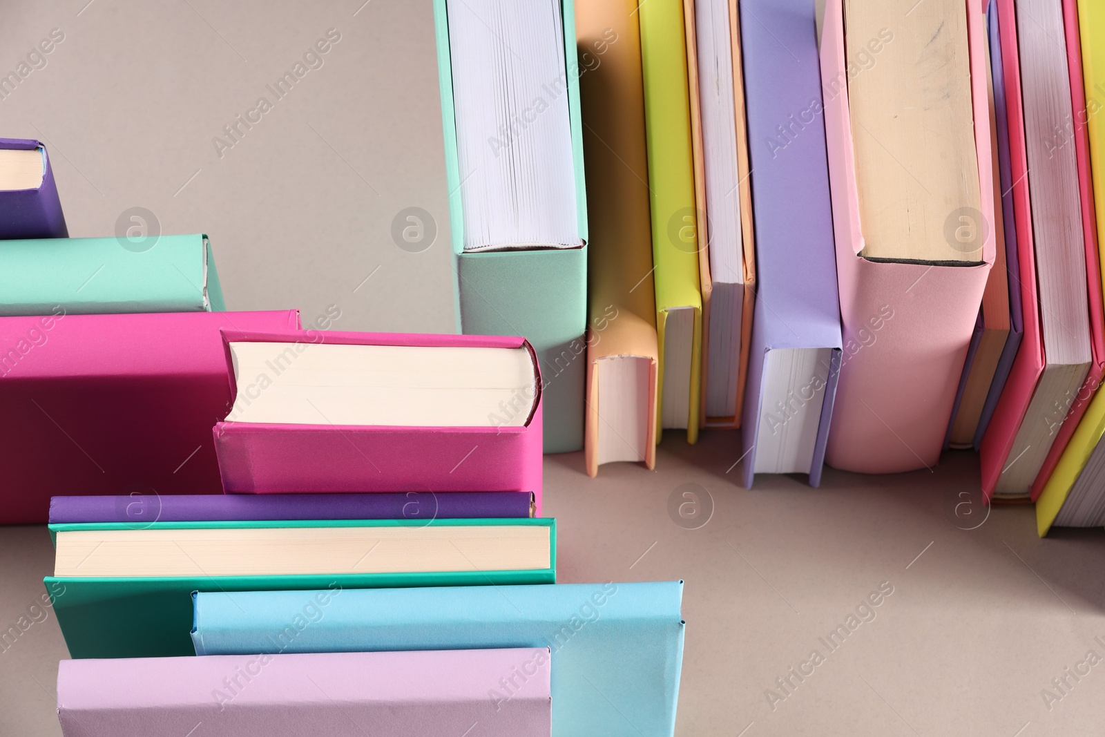 Photo of Many colorful books on beige background, above view