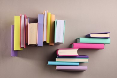 Photo of Many colorful books on beige background, flat lay