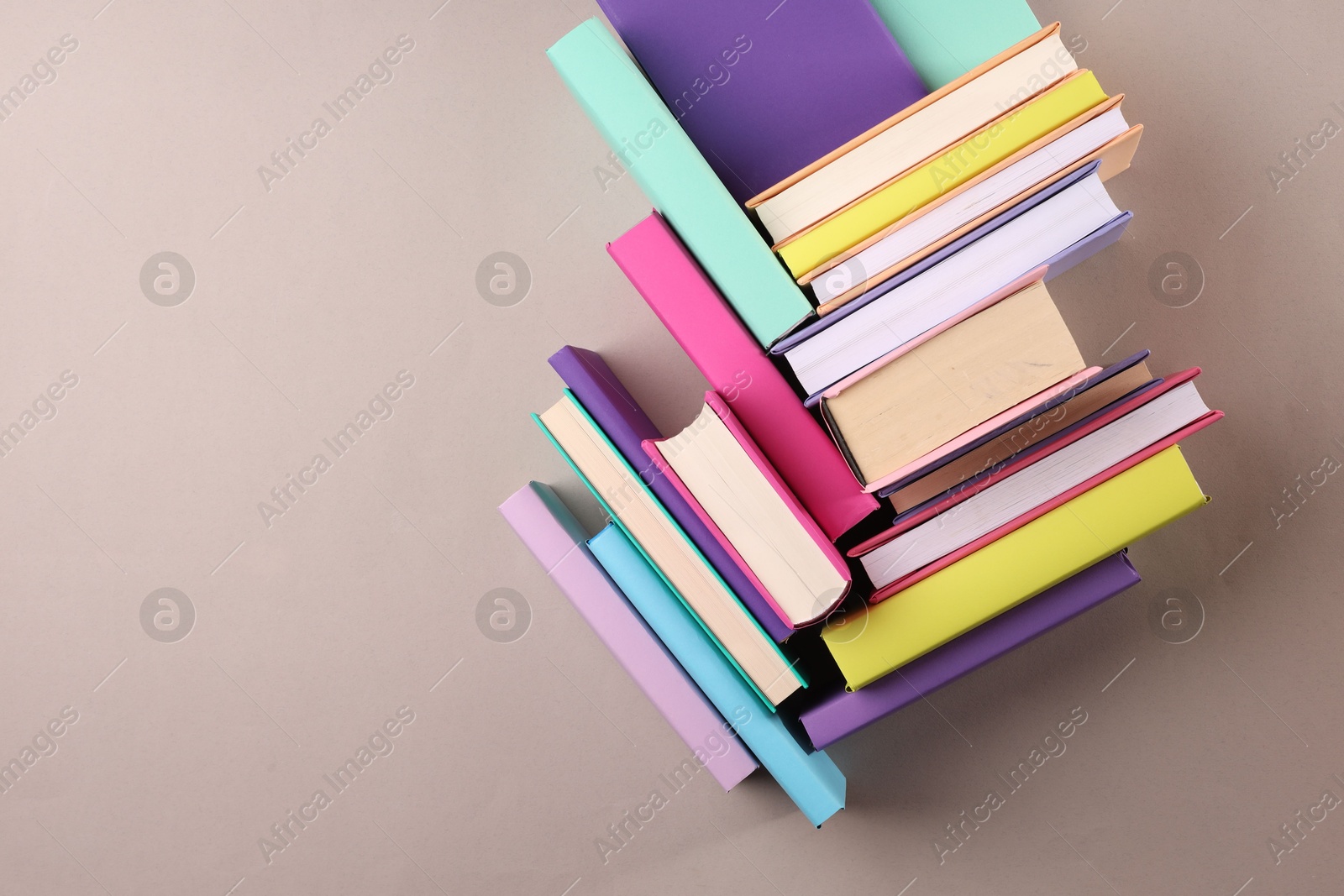 Photo of Many colorful books on beige background, flat lay. Space for text