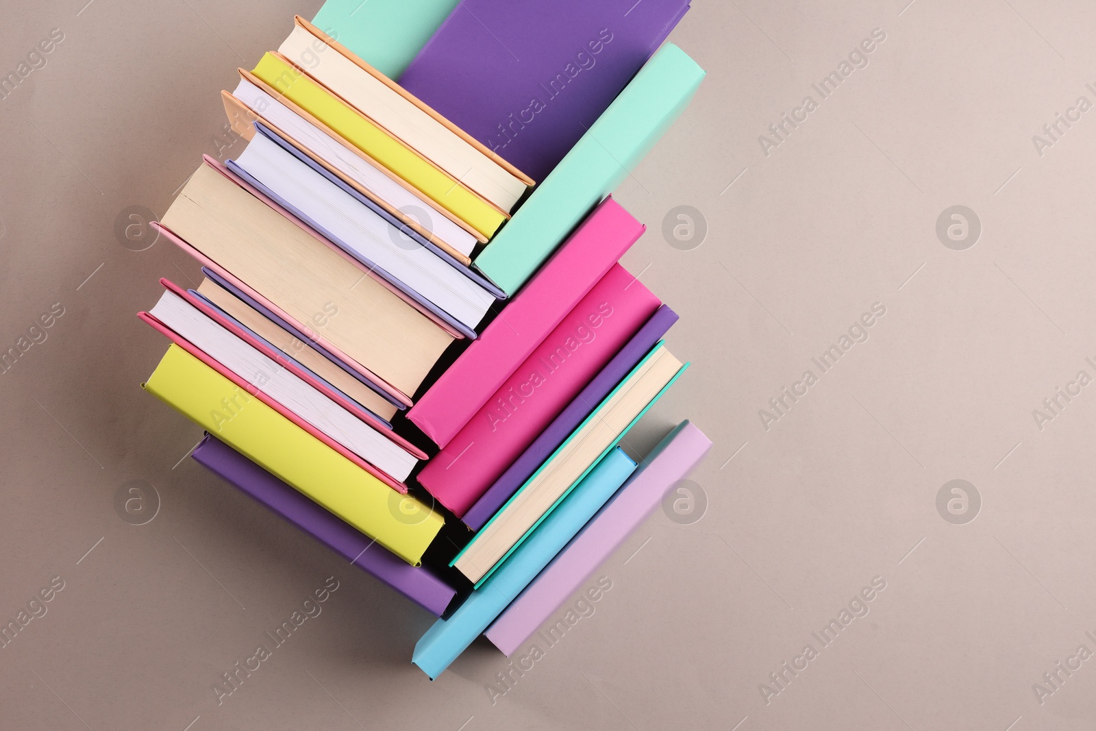 Photo of Many colorful books on beige background, flat lay. Space for text