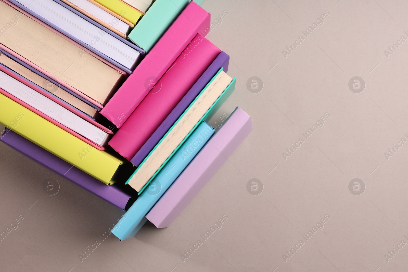 Photo of Many colorful books on beige background, flat lay. Space for text