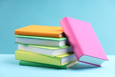 Many colorful books on light blue background