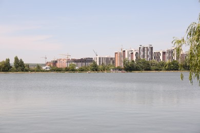 Picturesque view of city with lake and different buildings