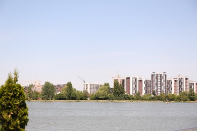 Photo of Picturesque view of city with lake and different buildings