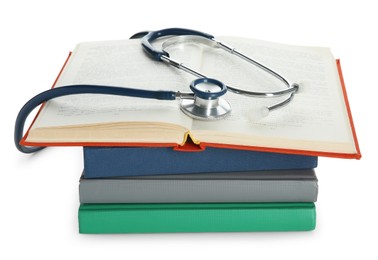 Stethoscope on stack of books against white background