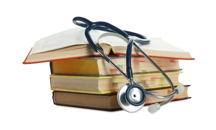 Stethoscope on stack of books against white background