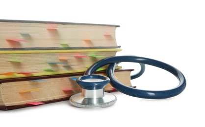 Stethoscope and stack of books isolated on white