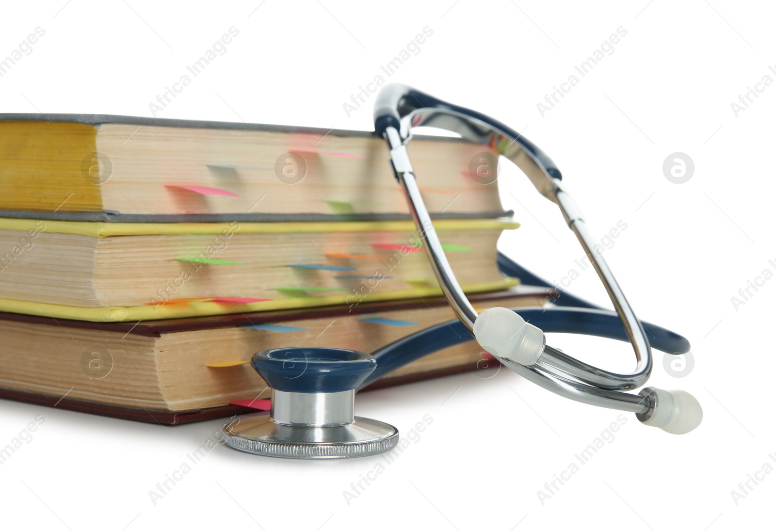 Photo of Stethoscope and stack of books isolated on white