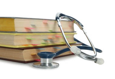 Photo of Stethoscope and stack of books isolated on white