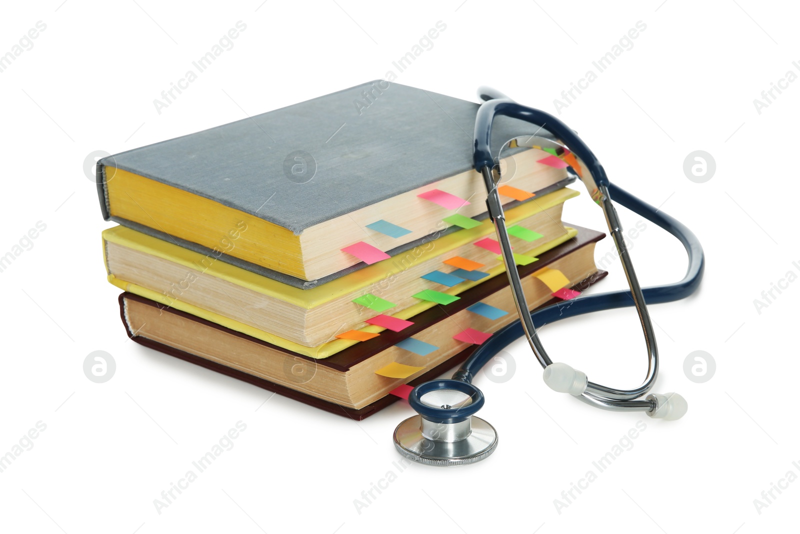 Photo of Stethoscope and stack of books isolated on white