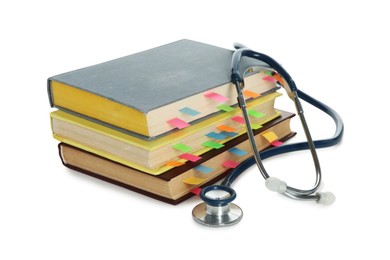 Photo of Stethoscope and stack of books isolated on white