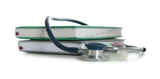 Stethoscope and stack of books isolated on white