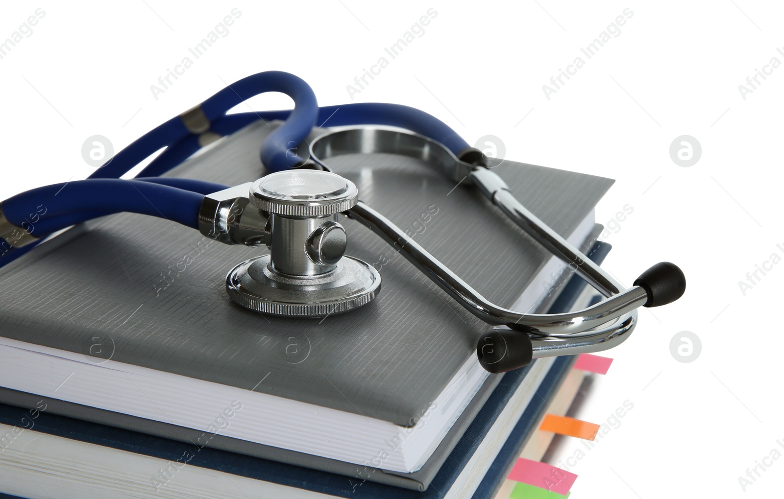 Photo of Stethoscope on stack of books against white background