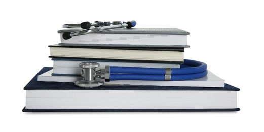 Photo of Stethoscope and stack of books isolated on white