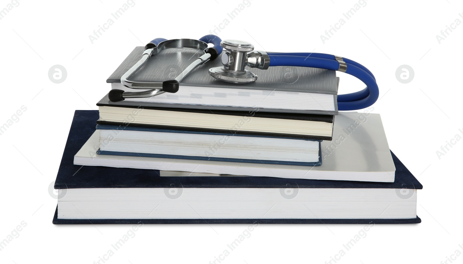 Photo of Stethoscope and stack of books isolated on white
