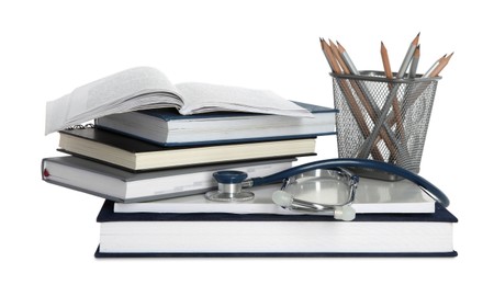 Photo of Stethoscope, stack of books and pencils isolated on white