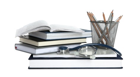 Photo of Stethoscope, stack of books and pencils isolated on white