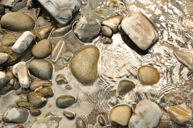 Many different stones in water, top view