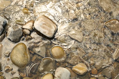 Many different stones in water, top view