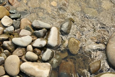 Many different stones in water, top view