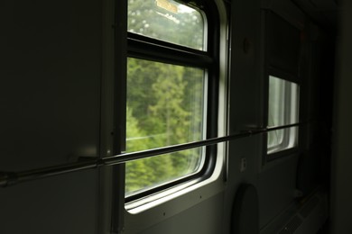 Windows and metal handrails in train car