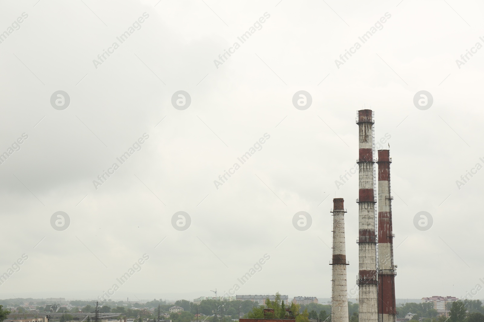 Photo of Modern power station in city on cloudy day, space for text