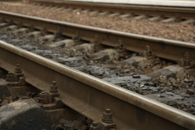 Metal railway lines outdoors in city, closeup view