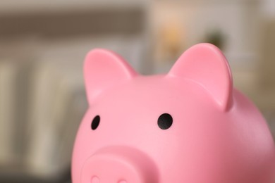 Photo of Pink piggy bank on blurred background, closeup