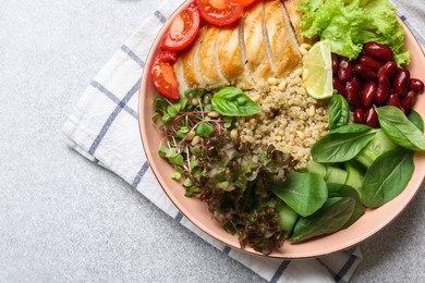 Photo of Healthy meal. Tasty vegetables, quinoa and chicken breast in bowl on white table, top view. Space for text