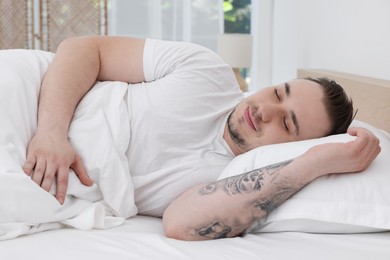 Photo of Bedtime. Handsome man sleeping in bed indoors